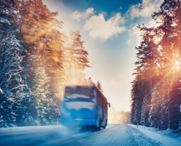 Bus,On,Asphalt,Road,In,Beautiful,Winter,Day,At,Countryside.